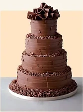 Kue cokelat bertingkat dengan hiasan serutan cokelat